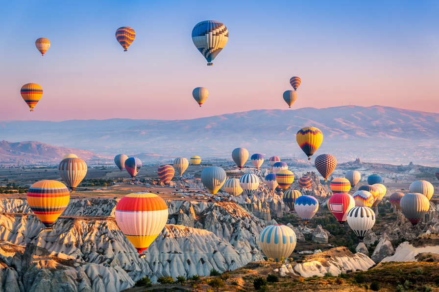 XeSIM Turkey eSIM data plans starting from £5.50, with hot air balloons over Cappadocia in the background.
